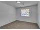 Bright bedroom featuring a large window and neutral carpet at 4670 E Boston Ave, Las Vegas, NV 89104