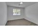 Bright bedroom featuring a large window and neutral carpet at 4670 E Boston Ave, Las Vegas, NV 89104