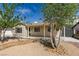 Charming front yard with mature trees and xeriscape landscaping at 4670 E Boston Ave, Las Vegas, NV 89104