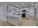 Updated kitchen with stainless steel appliances, white cabinetry, and breakfast bar area at 4670 E Boston Ave, Las Vegas, NV 89104