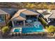 Stunning aerial view of backyard oasis featuring a sparkling pool, spa and outdoor living area at 47 Reflection Bay Dr, Henderson, NV 89011