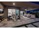 Stylish patio with seating areas, an outdoor kitchen, and easy access to the interior living spaces at 47 Reflection Bay Dr, Henderson, NV 89011