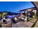 Backyard with a fire pit, covered patio, pool, outdoor kitchen, and beautiful mountain views at 47 Reflection Bay Dr, Henderson, NV 89011