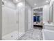 Modern bathroom featuring a glass-enclosed shower, marble floors, and a view into the bedroom at 47 Reflection Bay Dr, Henderson, NV 89011