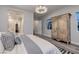 Bright bedroom featuring a decorative armoire, modern chandelier, and neutral color palette at 47 Reflection Bay Dr, Henderson, NV 89011