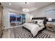 Elegant main bedroom featuring a king-sized bed, stylish decor, and access to the backyard patio at 47 Reflection Bay Dr, Henderson, NV 89011