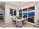 Cozy dining area with a round table, stylish chairs, and a view of the outdoor space at 47 Reflection Bay Dr, Henderson, NV 89011