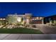 Charming single-story home featuring a stone facade, manicured lawn, and spacious two-car garage at 47 Reflection Bay Dr, Henderson, NV 89011