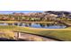 Scenic golf course view featuring a tranquil pond and picturesque mountain backdrop for luxury living at 47 Reflection Bay Dr, Henderson, NV 89011