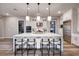 Spacious kitchen featuring a large island with seating, stainless steel appliances, and modern pendant lights at 47 Reflection Bay Dr, Henderson, NV 89011