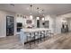 Bright kitchen features a large island with seating, stainless steel appliances, and stylish pendant lighting at 47 Reflection Bay Dr, Henderson, NV 89011