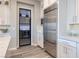 Bright kitchen with stainless steel fridge and a decorative glass door to the walk-in pantry at 47 Reflection Bay Dr, Henderson, NV 89011