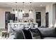 Cozy living room view showcasing open kitchen layout with stainless appliances and a quartz countertop island at 47 Reflection Bay Dr, Henderson, NV 89011