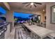 Beautiful outdoor kitchen and dining area, adjacent to the cozy lounge area and pool at 47 Reflection Bay Dr, Henderson, NV 89011