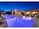 Stunning outdoor oasis with pool, water features, lounge chairs and covered patio for luxurious living at 47 Reflection Bay Dr, Henderson, NV 89011
