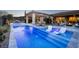 Beautiful pool with water features and lounge chairs offers a relaxing outdoor space at 47 Reflection Bay Dr, Henderson, NV 89011