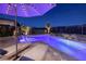 Relaxing pool area with lounge chairs, umbrella, and scenic views at twilight at 47 Reflection Bay Dr, Henderson, NV 89011
