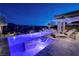 Beautiful pool at night with ambient lighting, lounge chairs and spa for relaxation at 47 Reflection Bay Dr, Henderson, NV 89011