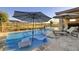 Stunning pool area with chaise lounges and umbrellas for luxurious outdoor relaxation at 47 Reflection Bay Dr, Henderson, NV 89011