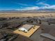 Aerial view of a residential area showcasing well-maintained homes and mountain views, under a blue sky at 4801 Westmont Dr, Pahrump, NV 89061