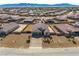 Aerial view of a well-maintained residential property with a paved driveway, lush landscaping, and a spacious backyard at 4801 Westmont Dr, Pahrump, NV 89061