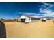 Wide backyard featuring a covered patio, well-maintained landscaping, and an open space for outdoor activities at 4801 Westmont Dr, Pahrump, NV 89061