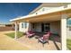 Inviting backyard with brick pavers, comfortable seating, a covered patio, and well-maintained landscaping at 4801 Westmont Dr, Pahrump, NV 89061