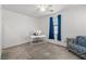 Well-lit bedroom with cozy carpet, desk setup, and a chair creating a comfortable living space at 4801 Westmont Dr, Pahrump, NV 89061