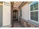 Inviting front entrance features stone accents, decorative wreath, and brick pathway leading to the door at 4801 Westmont Dr, Pahrump, NV 89061