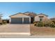 Charming single-Gathering home boasting a three-car garage, stone accents, desert landscaping, and a brick driveway at 4801 Westmont Dr, Pahrump, NV 89061