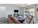 Spacious living room with a large sectional, sliding glass doors to patio, and contemporary decor at 4801 Westmont Dr, Pahrump, NV 89061