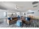 Open-concept living room flows to kitchen, featuring grey flooring, comfortable seating, and modern decor at 4801 Westmont Dr, Pahrump, NV 89061