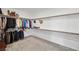 Spacious walk-in closet with wood shelving and ample room for storage and organization of clothes and shoes at 4801 Westmont Dr, Pahrump, NV 89061