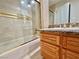 Bathroom showcasing tub/shower combo with tile surround and wood vanity at 5010 Longboat Cir, Las Vegas, NV 89113