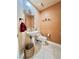 Cozy bathroom features pedestal sink, decorative mirror and textured wall at 5010 Longboat Cir, Las Vegas, NV 89113
