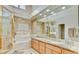 Elegant bathroom with double sinks, large mirrors, and a luxurious soaking tub with a gold framed shower at 5010 Longboat Cir, Las Vegas, NV 89113