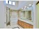Elegant bathroom with double sinks, granite countertops, tiled walls, and a glass-enclosed shower at 5010 Longboat Cir, Las Vegas, NV 89113