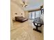 Spacious bedroom with high ceilings, a ceiling fan, tile floors, and access to the outdoors at 5010 Longboat Cir, Las Vegas, NV 89113