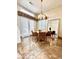 Inviting dining room with marble floors, a modern chandelier, and charming outdoor access at 5010 Longboat Cir, Las Vegas, NV 89113