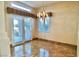 Elegant dining room featuring marble floors, decorative lighting, and access to the outdoors at 5010 Longboat Cir, Las Vegas, NV 89113