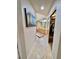 Hallway view leading to a bathroom, including a closet with mirror doors and organized shelves at 5010 Longboat Cir, Las Vegas, NV 89113