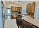 Well-appointed kitchen with updated appliances, custom wood cabinetry, and stone countertops for modern living at 5010 Longboat Cir, Las Vegas, NV 89113