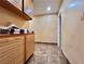 Laundry room features marble flooring and wood cabinet storage at 5010 Longboat Cir, Las Vegas, NV 89113