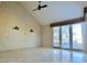 Bright living room with high ceilings, tile flooring, a ceiling fan, and access to the outdoors at 5010 Longboat Cir, Las Vegas, NV 89113