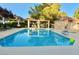 Community pool featuring lounge chairs and shaded seating area for residents at 5010 Longboat Cir, Las Vegas, NV 89113