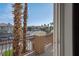Balcony area featuring decorative railings and views of the neighborhood street with tall, thin palm trees at 506 Staghorn Pass Ave, Las Vegas, NV 89183