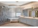 Bathroom with a glass shower, soaking tub, double sinks, and plenty of countertop space at 506 Staghorn Pass Ave, Las Vegas, NV 89183