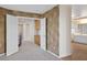 Stylish bedroom with painted walls leading to the connected bathroom and a glimpse of the upstairs hallway at 506 Staghorn Pass Ave, Las Vegas, NV 89183