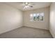 Neutrally-toned bedroom features a bright window for natural light, complemented by modern fixtures and neutral carpet at 506 Staghorn Pass Ave, Las Vegas, NV 89183