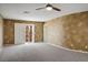 The spacious bedroom features carpeted floors, stylish accent walls, and a door to the balcony area at 506 Staghorn Pass Ave, Las Vegas, NV 89183